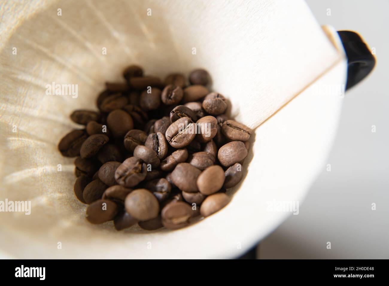 Roasted coffee beans in a coffee dripper Stock Photo