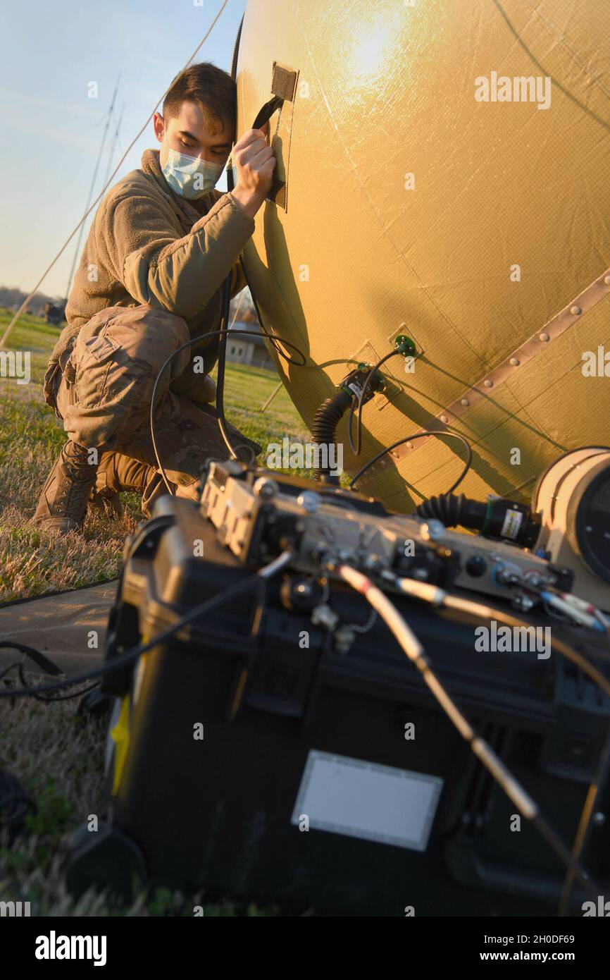 U.S. Air Force Staff Sgt. Frederick Van Riper, 621st Contingency Response Support Squadron mobile command, control, communications and computers supervisor, sets up the satellite dish for the small communications package Feb. 1, 2021, at the Alexandria International Airport, Louisiana. Airmen were able to employ new tent systems and a small communications package during a Joint Readiness Training Center exercise Jan. 31-Feb. 9 in Louisiana. Stock Photo