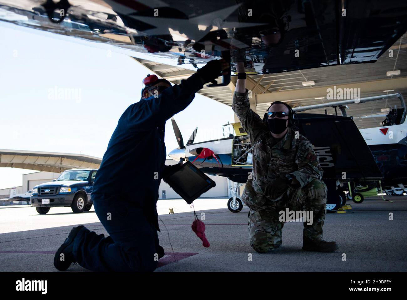 Col. Craig Prather, 47th Flying Training Wing commander, joins chief of maintenance George Hernandez on the flight line to look over the T-6A Texan II on Feb. 01, 2021, Laughlin Air Force Base, Texas. This visit was part of Col. Prather’s immersion with the maintenance teams on the flight line. Stock Photo