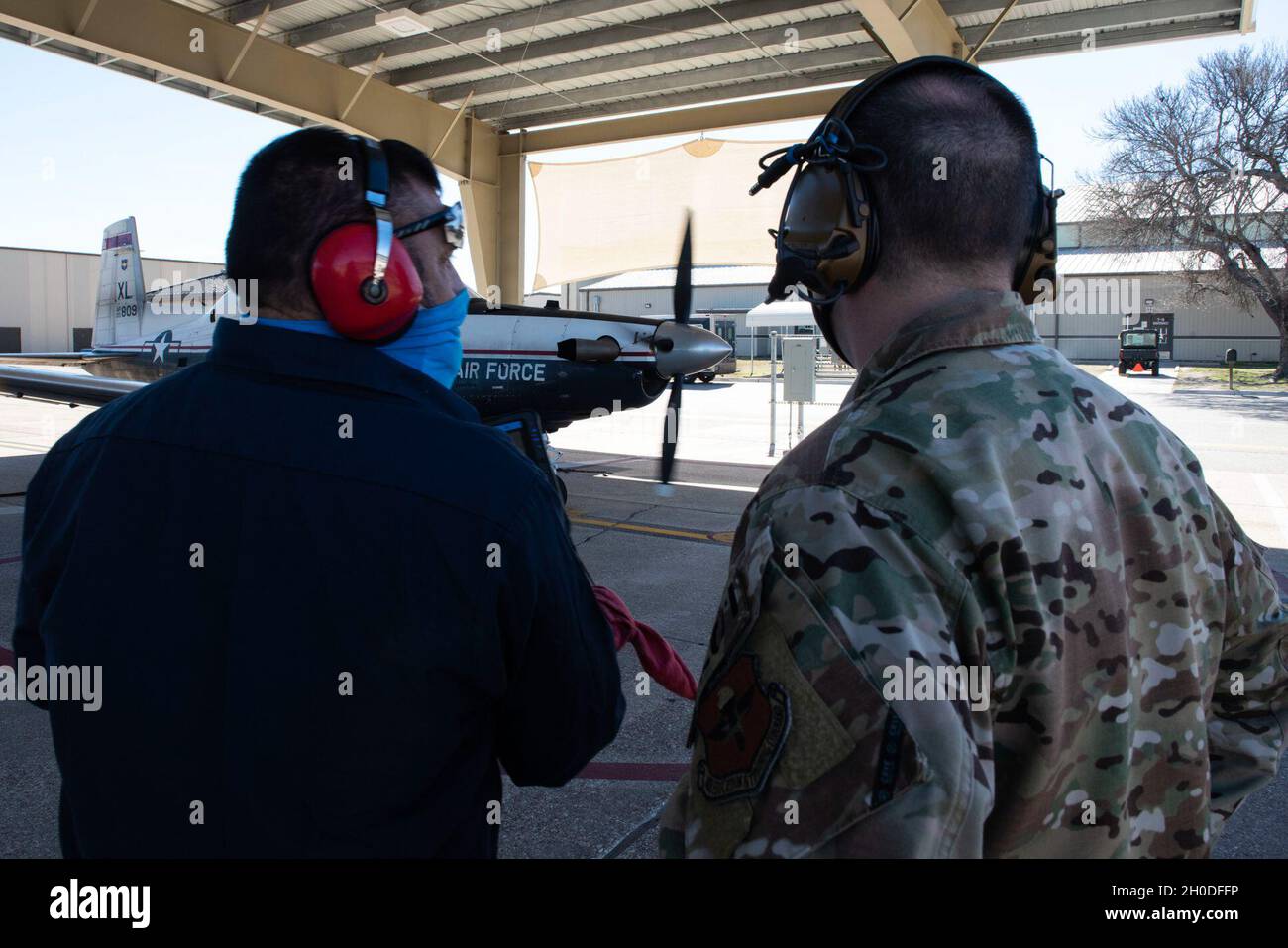 Col. Craig Prather, 47th Flying Training Wing commander, joins chief of maintenance George Hernandez on the flight line to look over the T-6A Texan II on Feb. 01, 2021, Laughlin Air Force Base, Texas. This visit was part of Col. Prather’s immersion with the maintenance teams on the flight line. Stock Photo