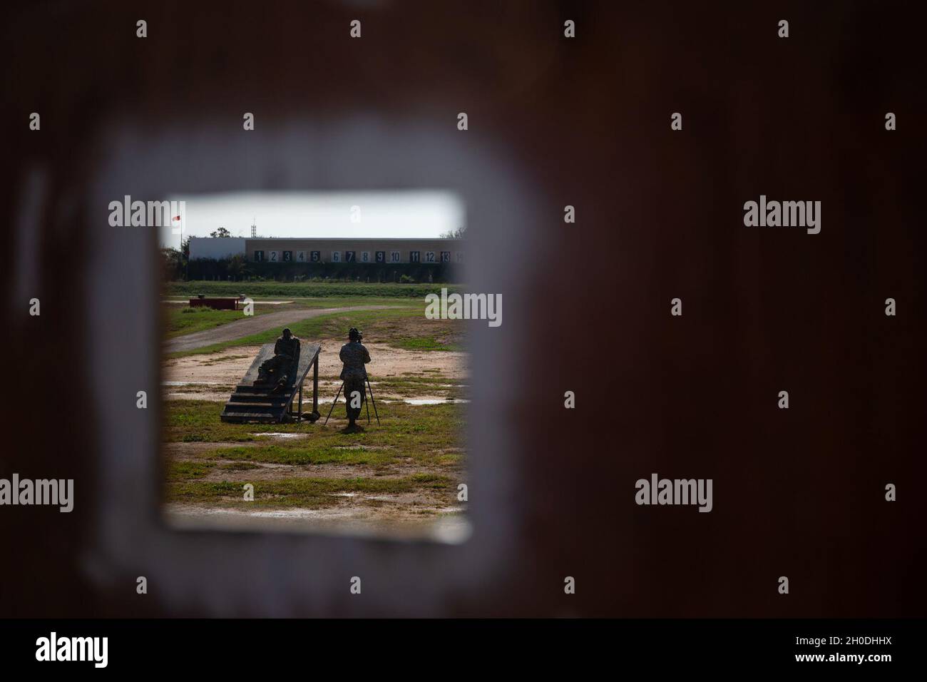 A U.S. Marine fires a rifle while prone on a ramp during the Marine ...