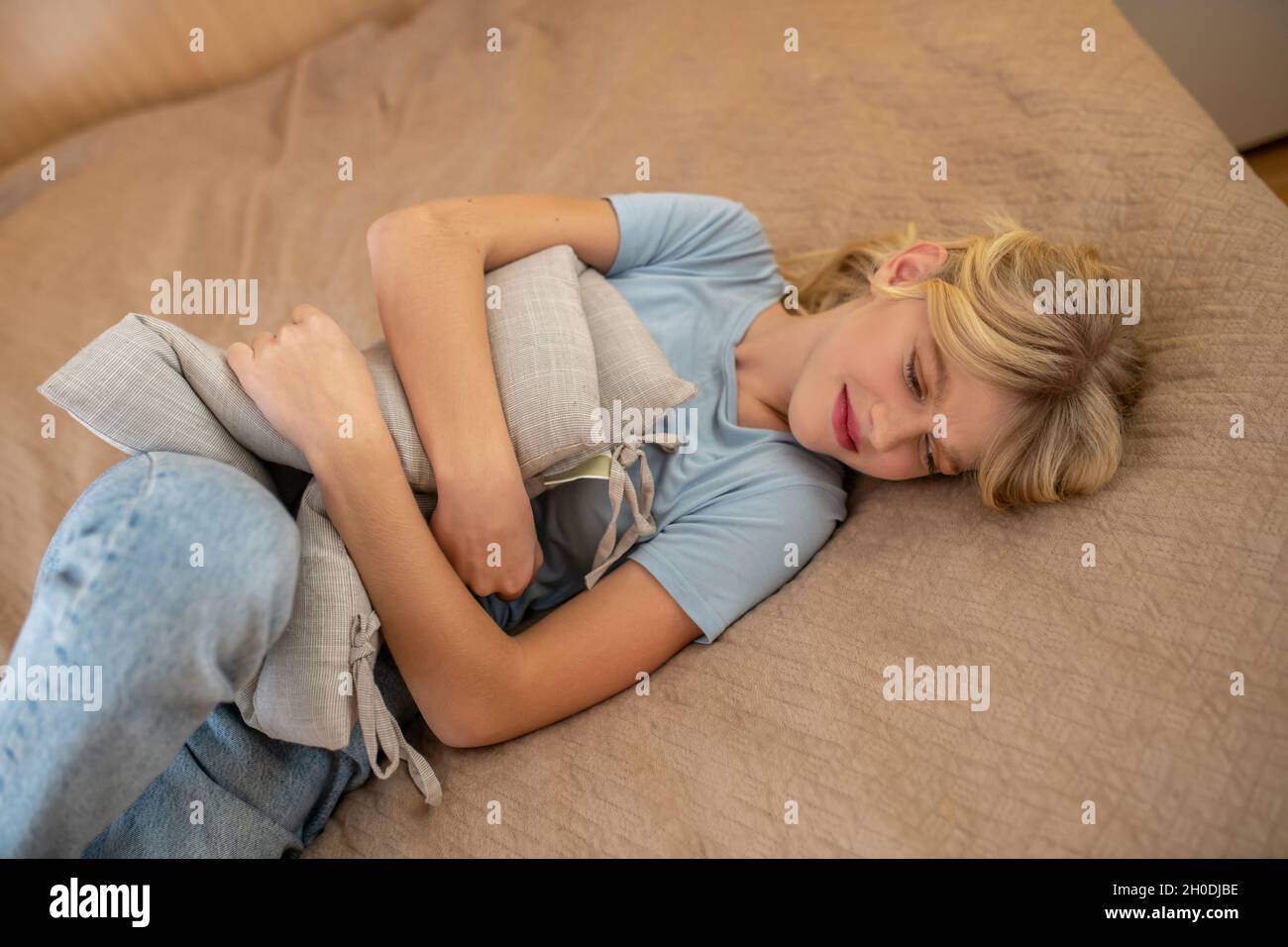 A girl having her critical days and suffering from pain Stock Photo