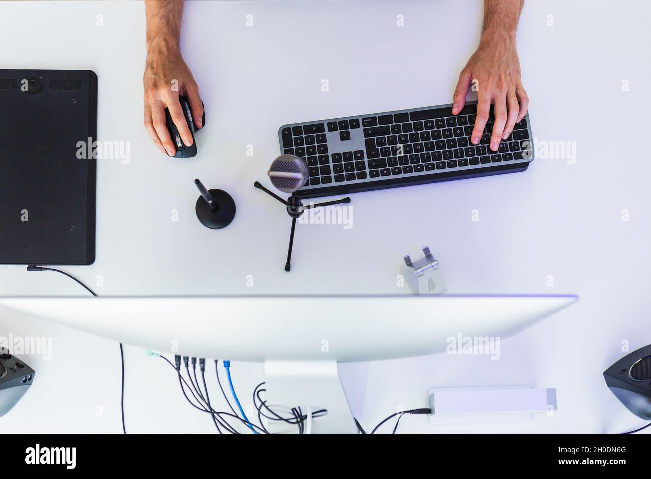 Anonymous male working on computer at table with graphic tablet Stock Photo