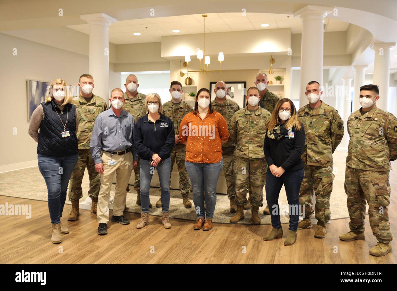 Members of a Kentucky National Guard Facility Support Support Team and Sayre Christian Village staff, pose for a group photo during a command visit in Lexington, Ky., 3 Feb. Kentucky Gov. Andy Beshear directed troops to supplement long term healthcare facilities in COVID 19 hot spots throughout Kentucky. Stock Photo