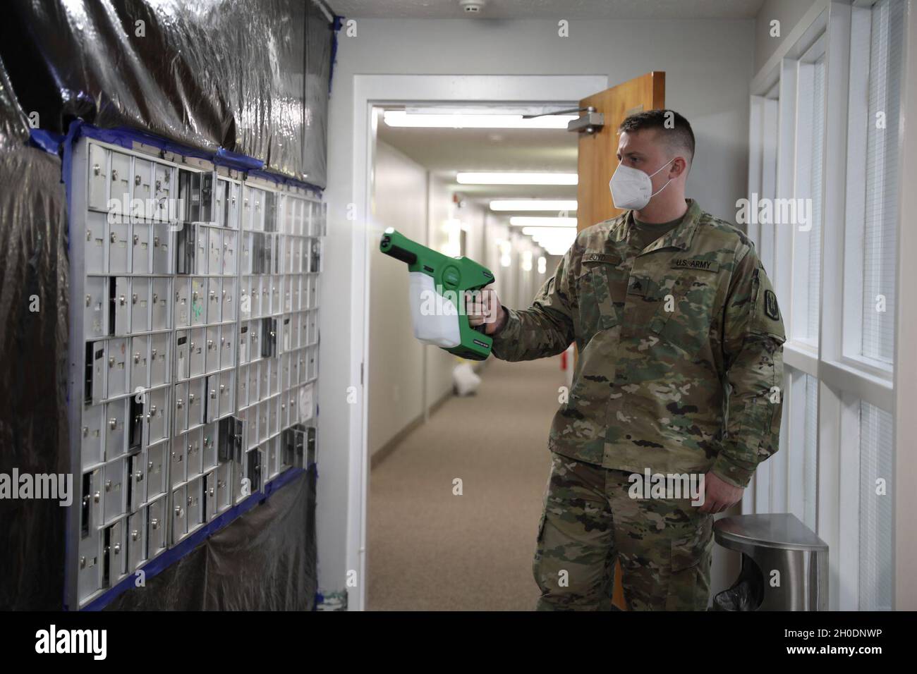 Spc. Quinton Boyd, a member assigned to a Facility Assistance Support Team, Kentucky National Guard, sanitizes mailboxes with an electrostatic sprayer while at Sayre Christian Village, Lexington, Ky., 3 Feb. Kentucky Gov. Andy Beshear directed troops to supplement long term healthcare facilities in COVID 19 hot spots throughout Kentucky. Stock Photo