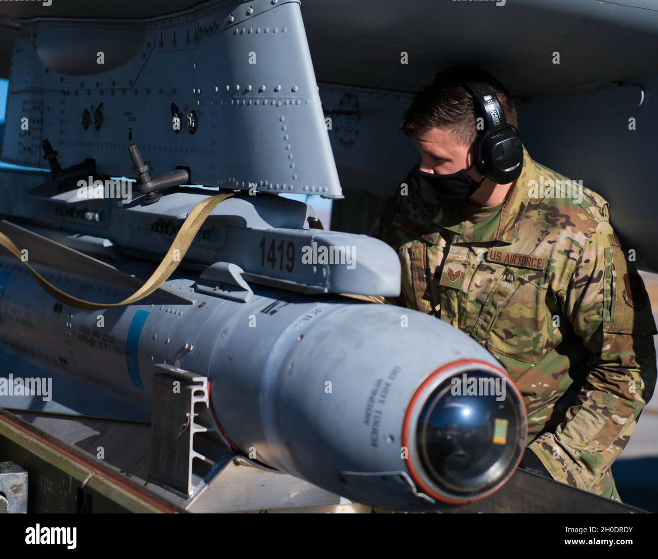 U.S. Air Force Tech. Sgt. Kacey Johnson, a weapons load crew member assigned to the 122nd Fighter Wing, Indiana Air National Guard, installs an AGM-65 Maverick missile on an A-10C Thunderbolt II aircraft during Red Flag 21-1 at Nellis Air Force Base, Nevada, Feb. 4, 2021. Red Flag 21-1 is hosting about 2,400 participants from nearly 20 states, multiple nations, and several sister services. Stock Photo