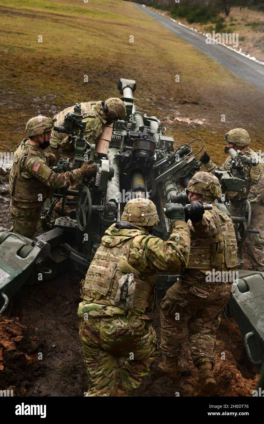 U.S. Soldiers assigned to Cobra Battery, Field Artillery Squadron, 2nd Cavalry Regiment, conduct a direct fire exercise with M777 Howitzers, Grafenwoehr Training Area in Bavaria, Germany, Feb. 04 2021. Stock Photo