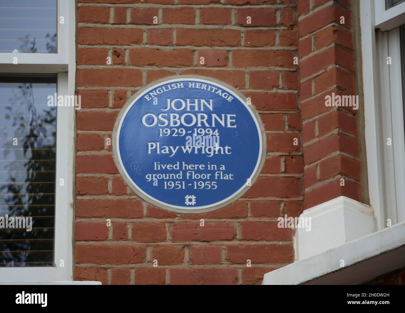 english heritage blue plaque marking a 1950s home of playwright john osborne, hammersmith, london, england Stock Photo