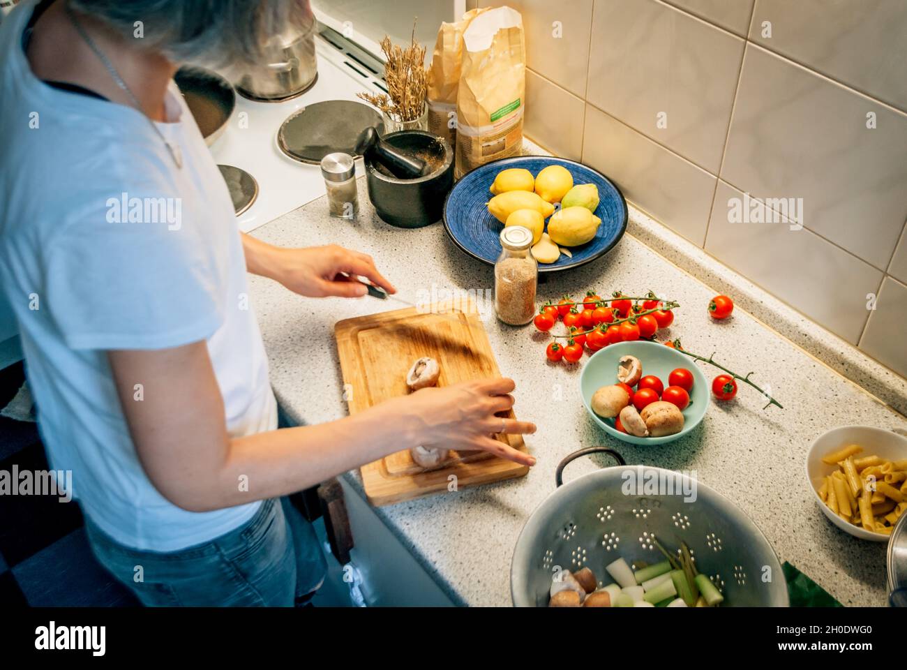 A woman cooks dinner in the kitchen of the house, top view Stock Photo