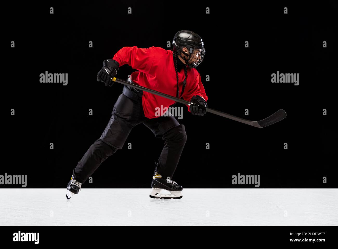 Fulllength side view portrait of woman, professional hockey player in