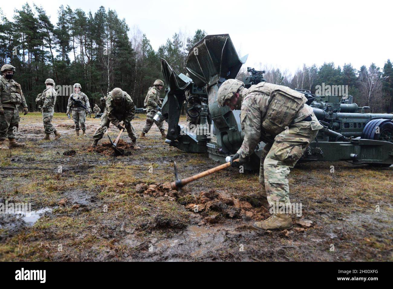 U.S. Soldiers assigned to the Cobra Battery, Field Artillery Squadron, 2nd Cavalry Regiment prepare to conduct direct fire missions with an M777 towed 155 mm howitzer at the Grafenwoehr Training Area, Germany, Feb. 4, 2021. Stock Photo