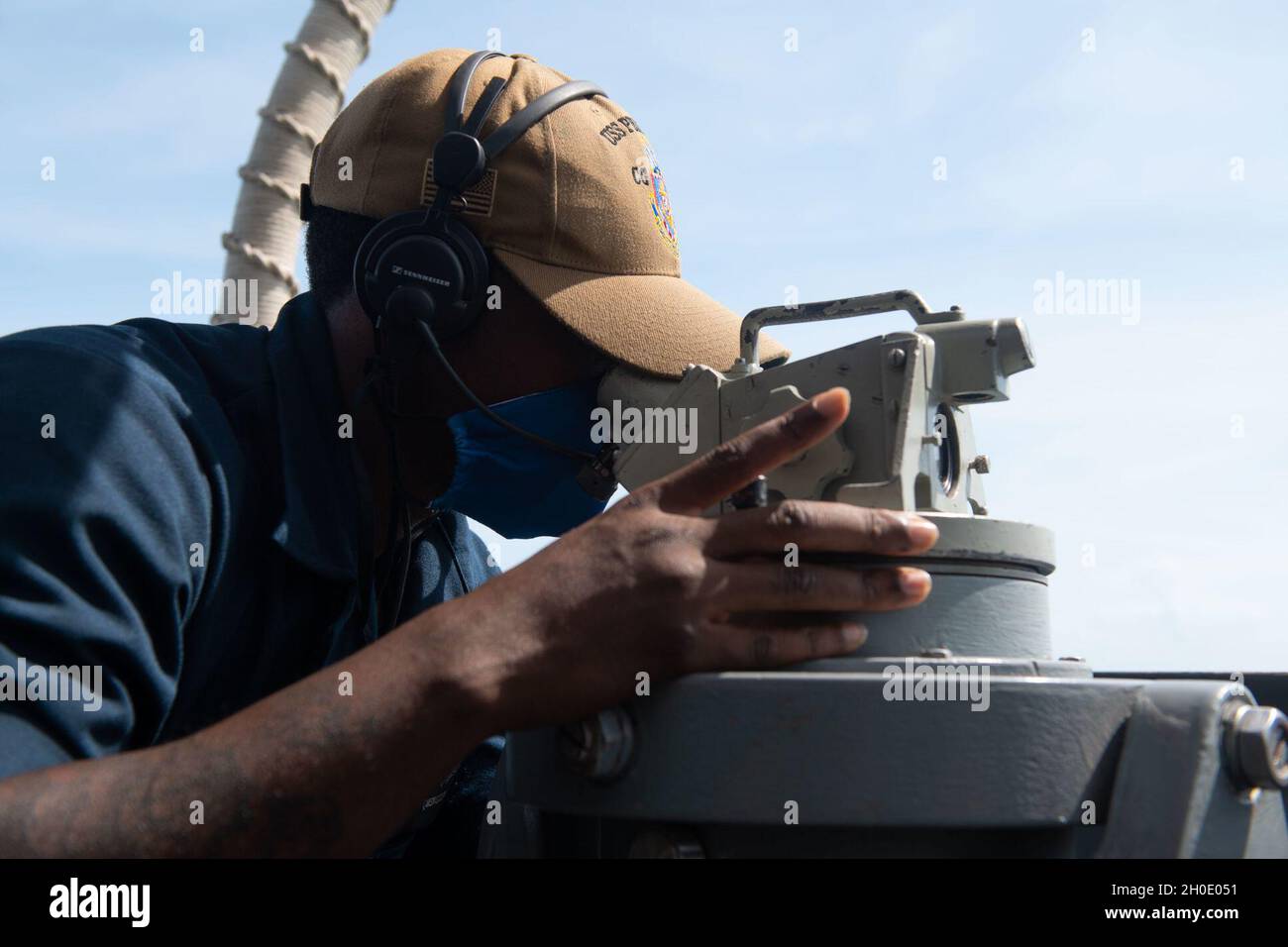 210205-N-OW019-0023 STRAIT OF MALACCA (Feb. 5, 2020) Quartermaster Seaman Vincent Green, from Jacksonville, Fla., uses a telescopic alidade to monitor the course of the guided-missile cruiser USS Princeton (CG 59) during a transit of the Strait of Malacca. Princeton is part of Nimitz Carrier Strike Group and is deployed conducting maritime security operations and theater security cooperation efforts. Stock Photo