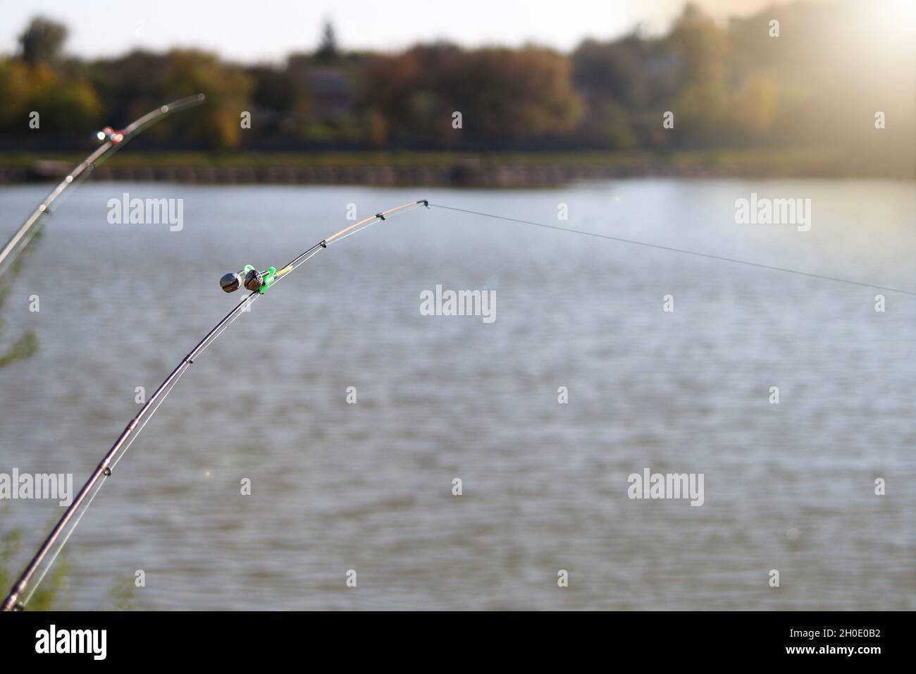 Peck-bell signal, on the tip of the fishing rod. Bell attachment for night  and day fishing on a lake or river. Fishing tackle. Sports and hobbies. Fis  Stock Photo - Alamy