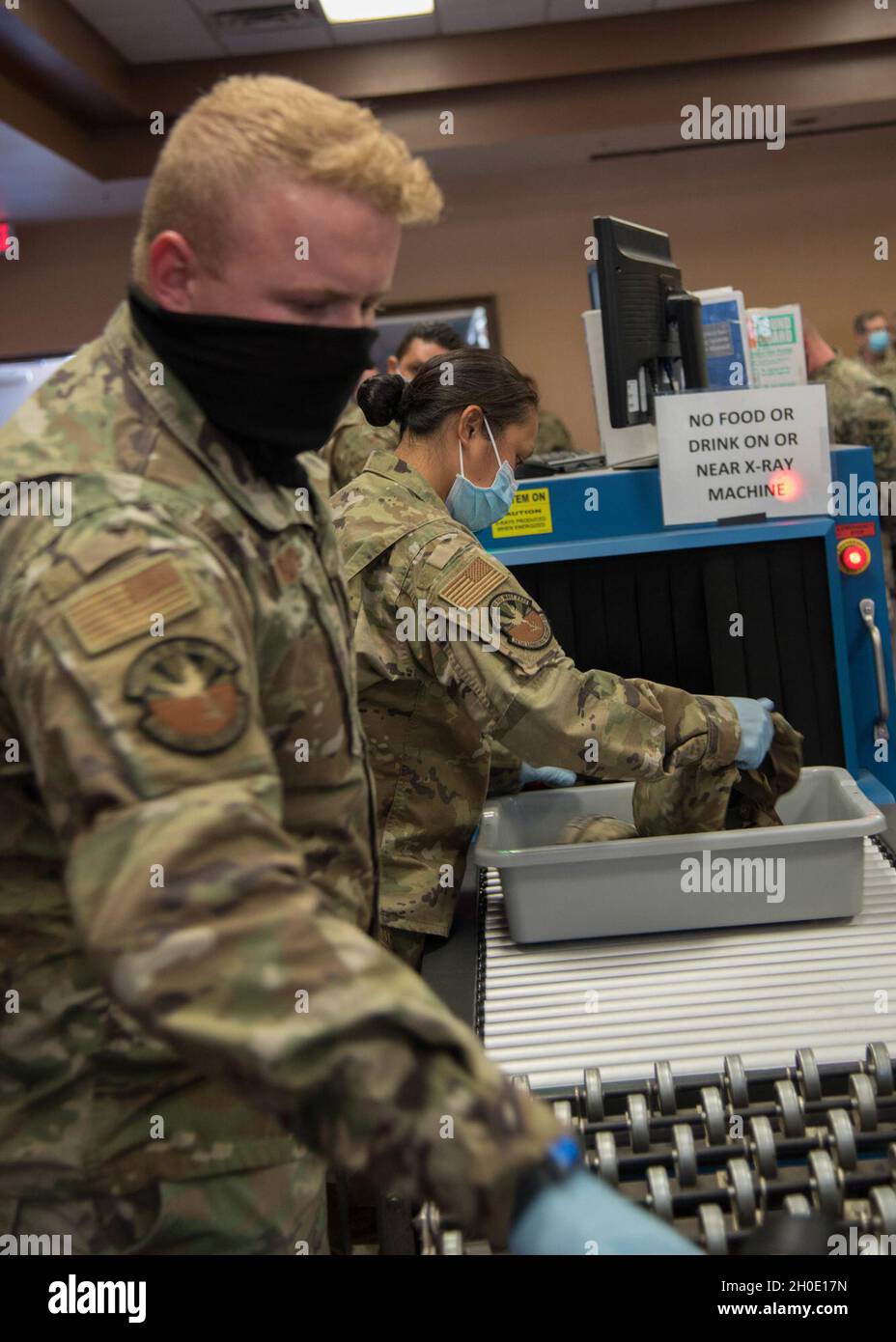 Members of the Arizona National Guard’s 161st Logistic Readiness Squadron inspect equipment at a pre-flight security checkpoint during a mobilization exercise at the Goldwater Air National Guard Base in Phoenix, Arizona Feb. 5, 2021. This exercise demonstrated the joint readiness capability of the Arizona Army and Air National Guard to mobilize domestic response capabilities on short notice. Stock Photo