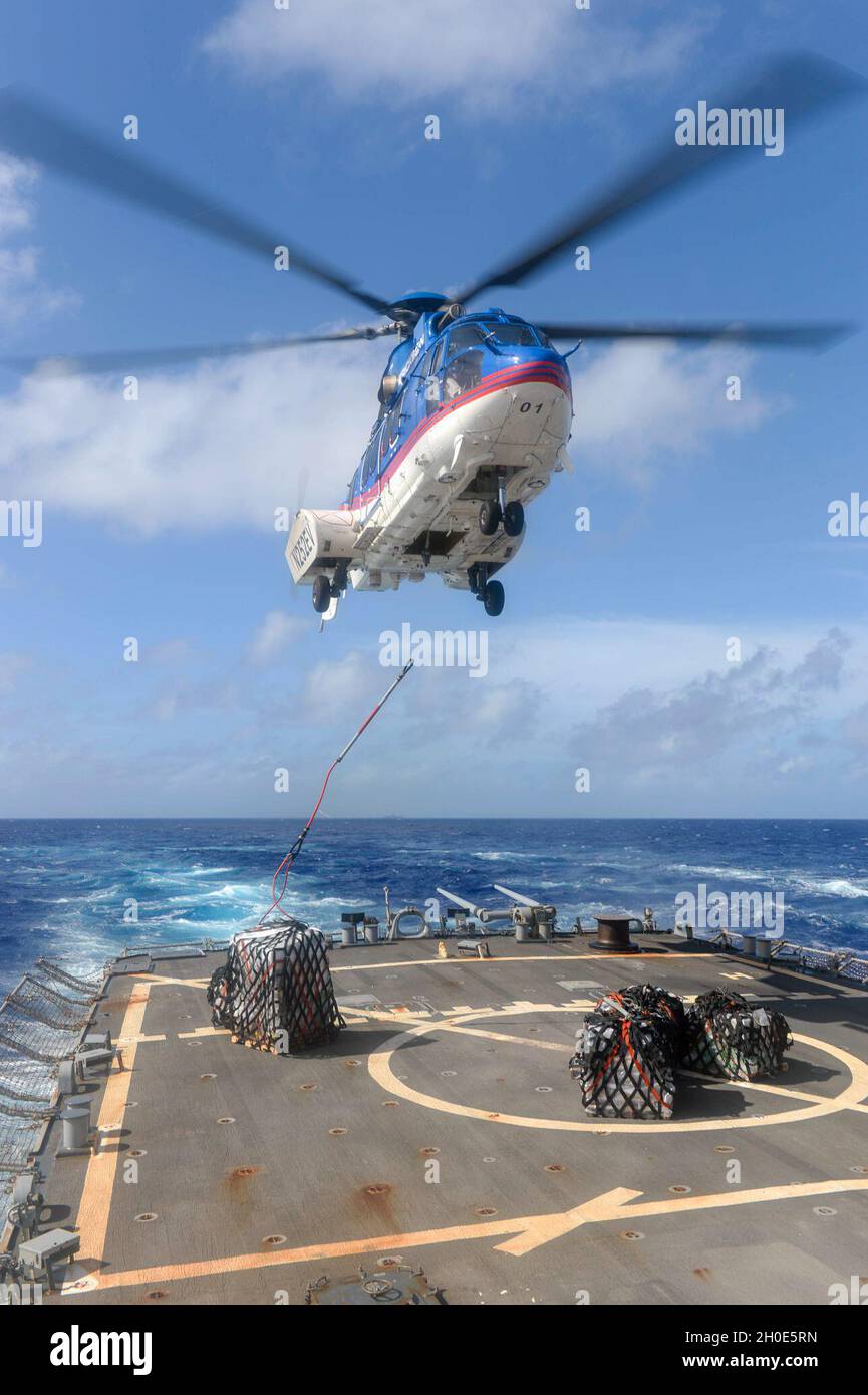 PACIFIC OCEAN (Feb. 7, 2021) An H225 Super Puma helicopter, assigned to the  Military Sealift Command dry cargo and ammunition ship USNS Alan Shepard  (T-AKE 3), delivers supplies to the flight deck