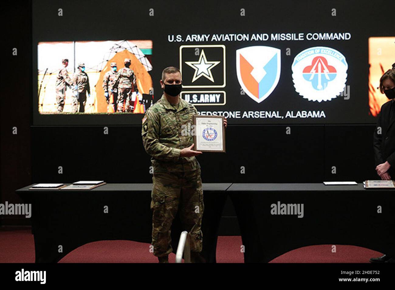 U.S. Army Aviation and Missile Command Commanding General Maj. Gen. Todd Royar displays one of the plaques presented to awardees during the Value Engineering/ Army Working Capital Fund Investment Program Awards Ceremony Feb. 8 at Bob Jones Auditorium at Redstone Arsenal, Alabama. Stock Photo