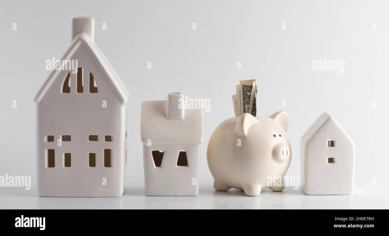 Houses and a Piggy Bank on a White Background Stock Photo - Alamy