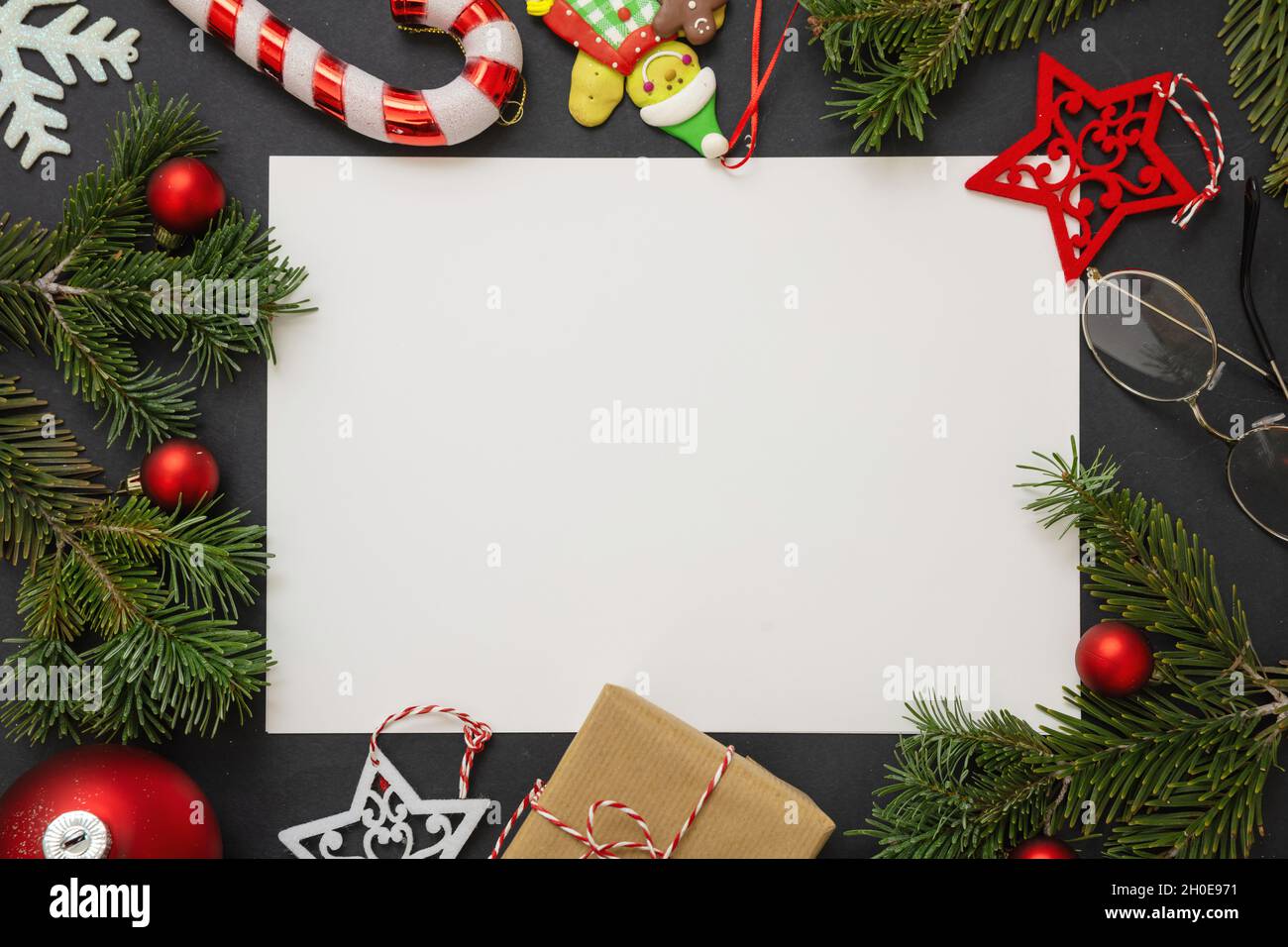 Christmas decoration and blank white card on black background. Gift box and  holiday ornaments, Xmas and New Year greeting card template, top view Stock  Photo - Alamy