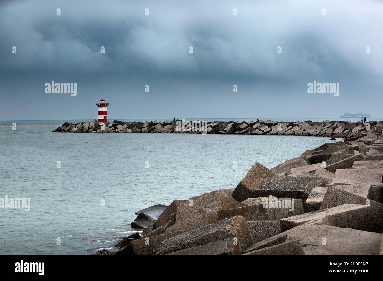 Safety beacon and rain clouds in Scheveningen in the Netherlands Stock Photo
