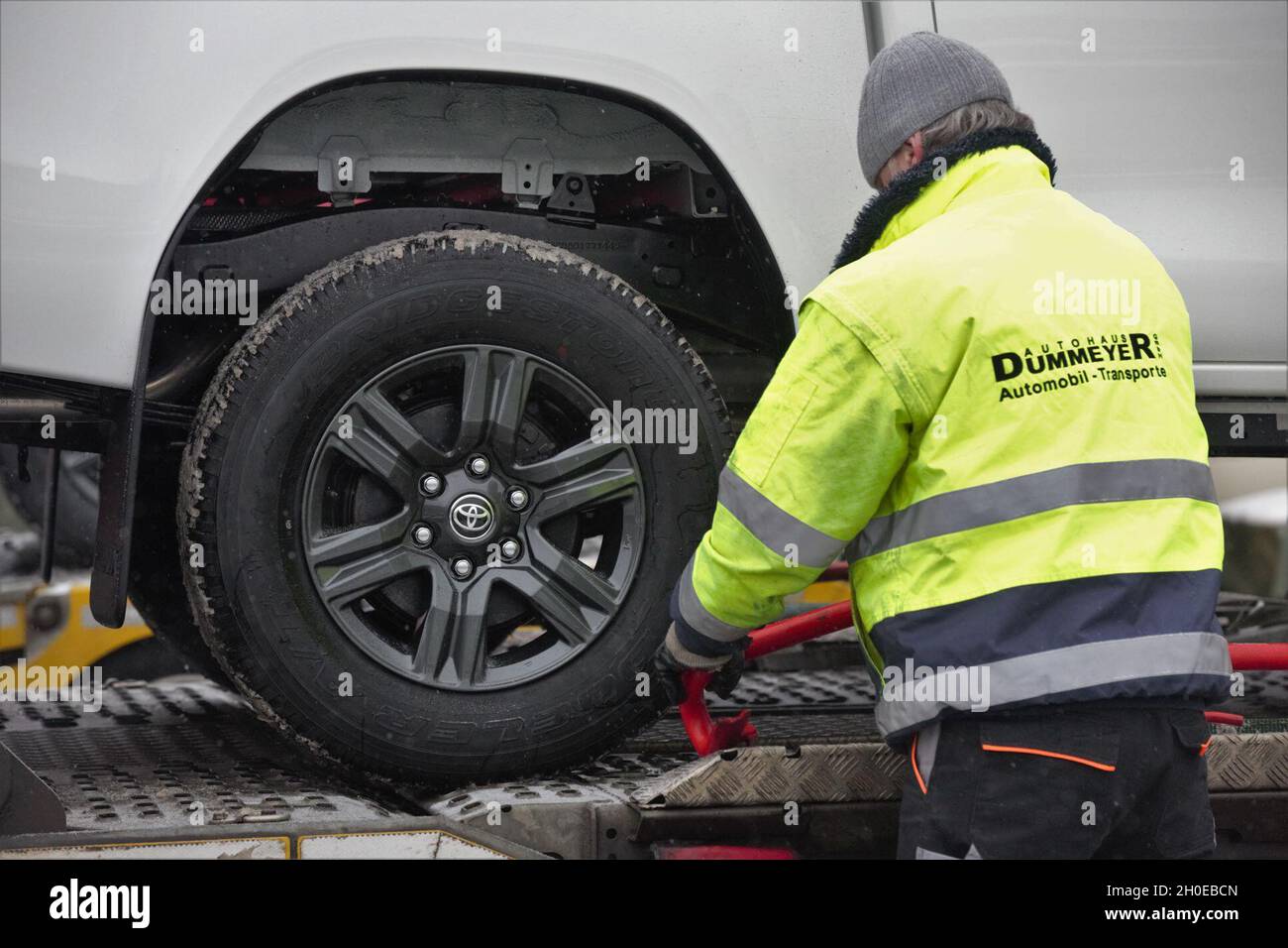 Autohaus Dummeyer employees unload a vehicle from a car carrier trailer. The Hohenfels