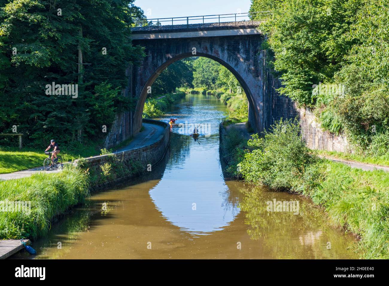 Walk on the towpath along the Ille et Rance Canal: kayak passing under the railroad bridge just before arriving at the lock of saint Medard sur Ille ( Stock Photo