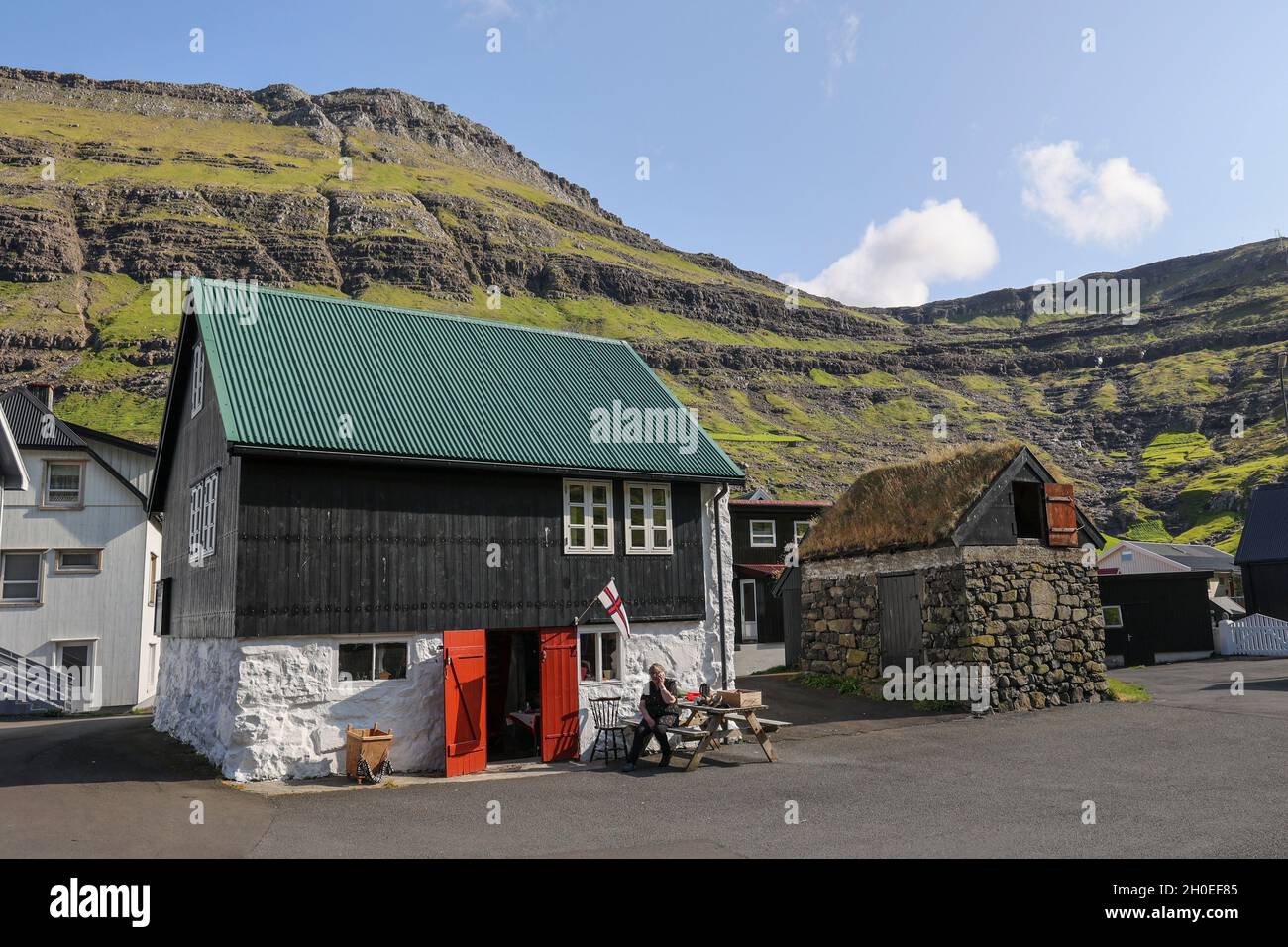Traditional wooden house with a green tin roof in Tjornuvik, Streymoy Island, Faroe Islands,Scandinavia,Europe. Stock Photo