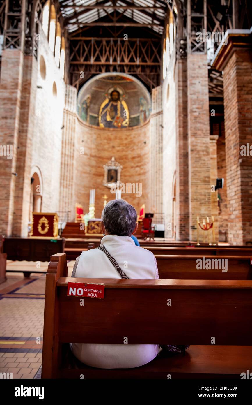 PEREIRA, COLOMBIA - JULY 2021. Senior woman praying at the historical Cathedral of Our Lady of Poverty of Pereira, built in 1890 Stock Photo