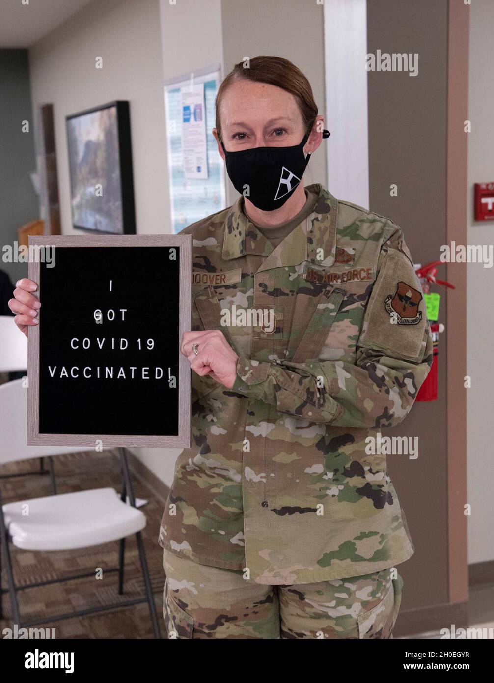 U.S. Air Force Chief Master Sgt. Laura Hoover, the 97th Operations Support Squadron superintendent, poses for a photo after receiving the COVID-19 vaccine February 12, 2021, at Altus Air Force Base, Oklahoma. Hoover explained she volunteered for the COVID-19 vaccine because she wanted to help protect herself and others from the spread of COVID-19. Stock Photo