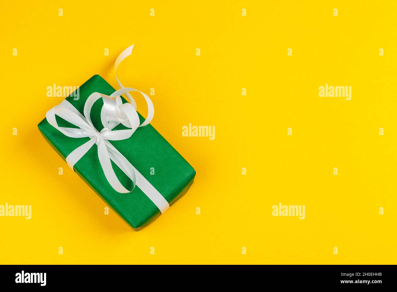 Decorated colored present on yellow background flatlay Stock Photo - Alamy