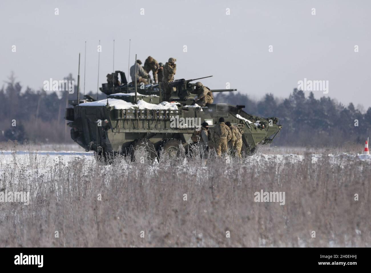 U.S. Army Soldiers from  Comanche Troop,  1st Squadron, 2d Cavalry Regiment, enhanced Forward Presence Battle Group Poland, swarm a stryker to prepare it for   the range during a gunnery qualification at Bemowo Piskie Training Area, Poland. Stock Photo