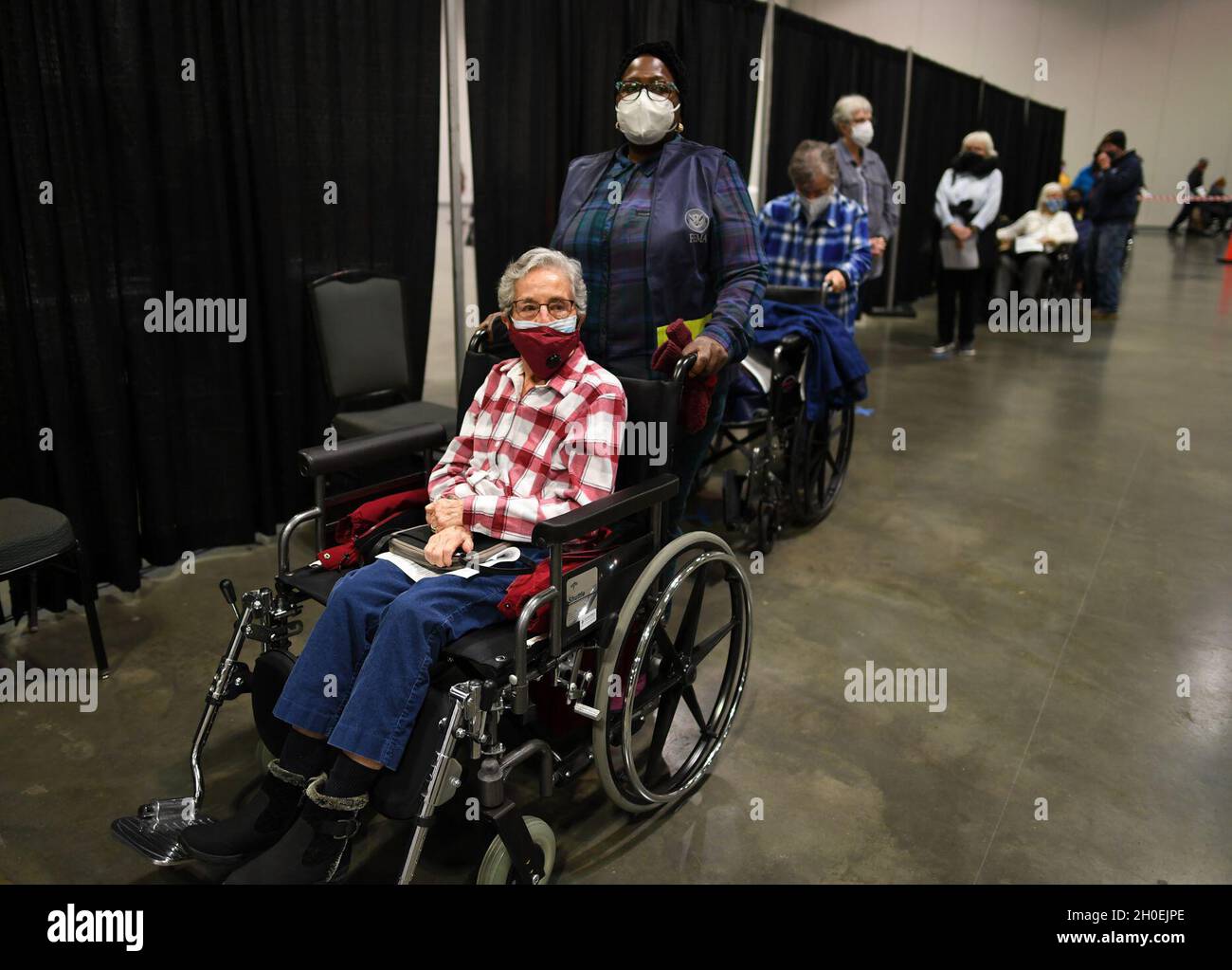 Nashville, TN (February 13, 2021) A FEMA staffer assists local resident, Sister Nena De Matteo, at the Music City Convention Center where a Covid vaccination site has been set up by the state and local officials. Stock Photo
