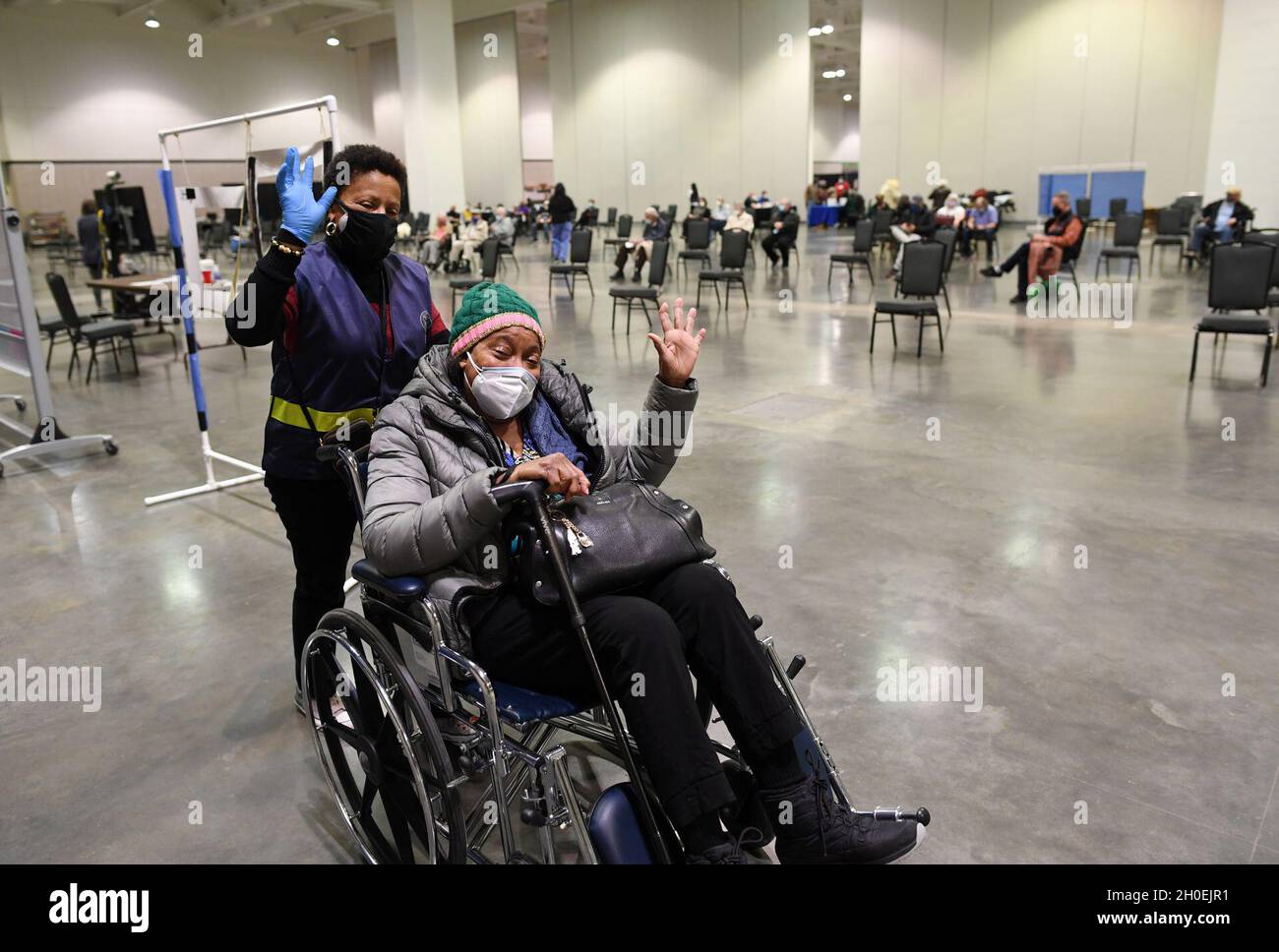 Nashville, TN (February 13, 2021) Local resident Fanny Carlisle, right, gets assistance from a FEMA staffer during her visit to the Music City Convention Center where a Covid vaccination site has been set up by the state and local officials. Stock Photo