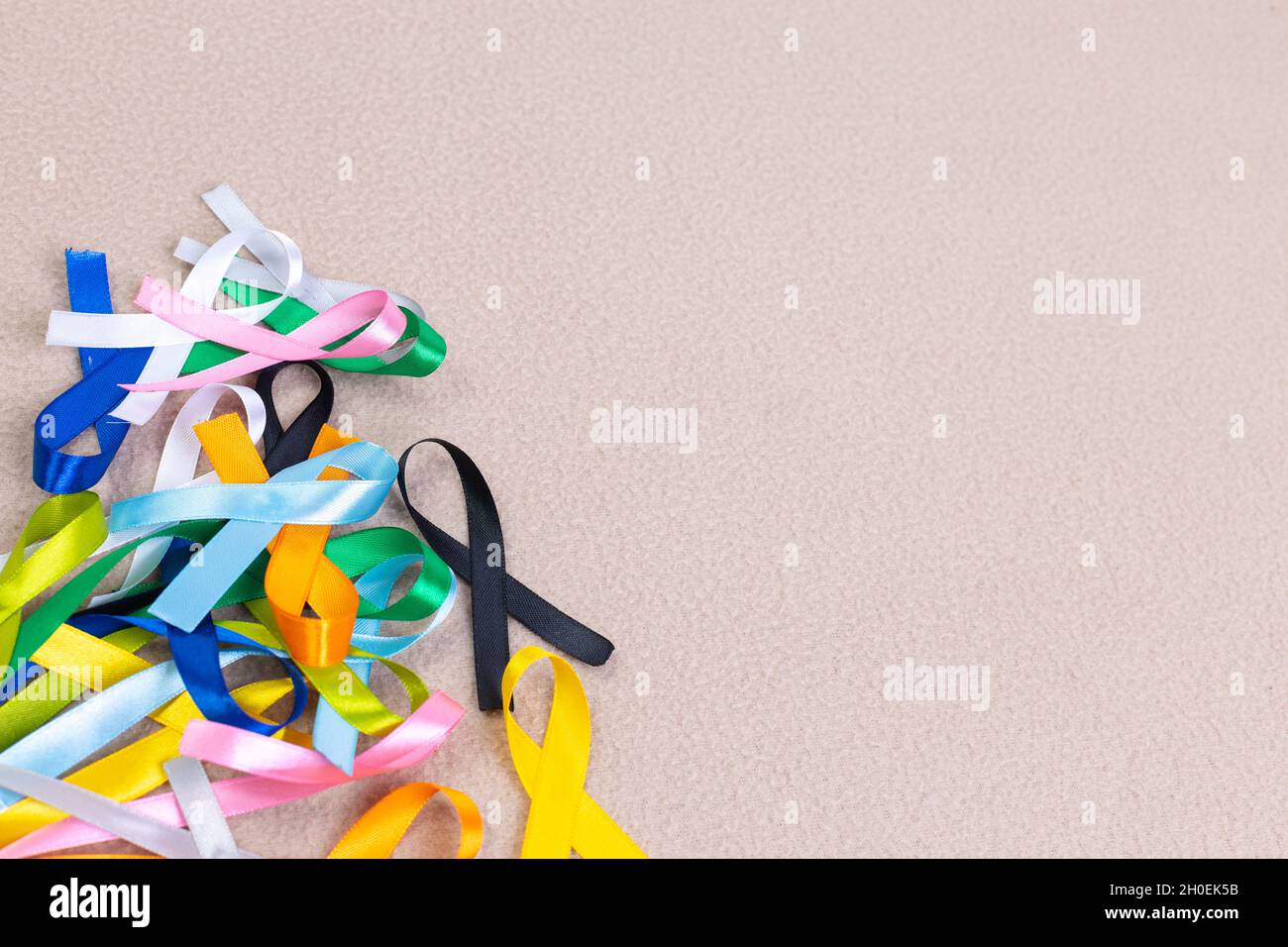 Colorful cancer ribbons isolated on a cream background Stock Photo - Alamy