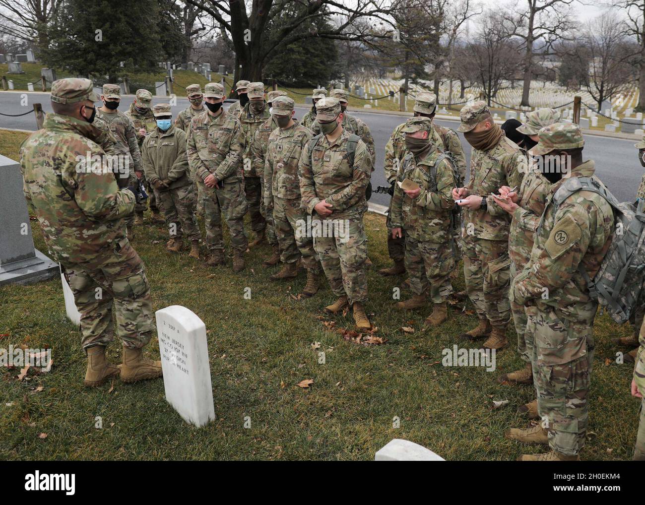 U.S. Soldiers with the 27th Infantry Brigade Combat Team, 42nd Infantry Division, New York National Guard, learn about the history and heroic actions of Medal of Honor recipient Sgt. Alan L. Eggers during a visit to the Arlington National Cemetery in Arlington, Va., Feb. 14, 2021.  Eggers, a World War I veteran of the New York National Guard’s 27th Infantry Division, received the Medal of Honor with two other Soldiers for their heroic actions in combat near Le Catelet, France, Sept. 29, 2918. Stock Photo