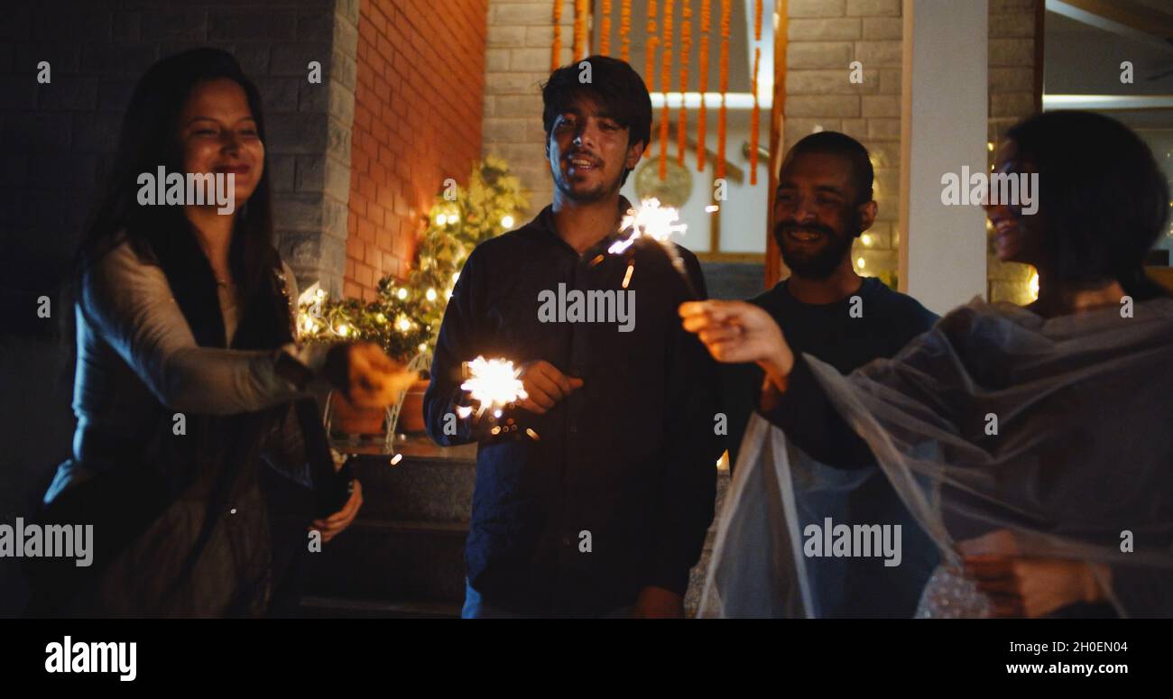 Indian people with burning Bengal lights; Deepavali celebration Stock Photo