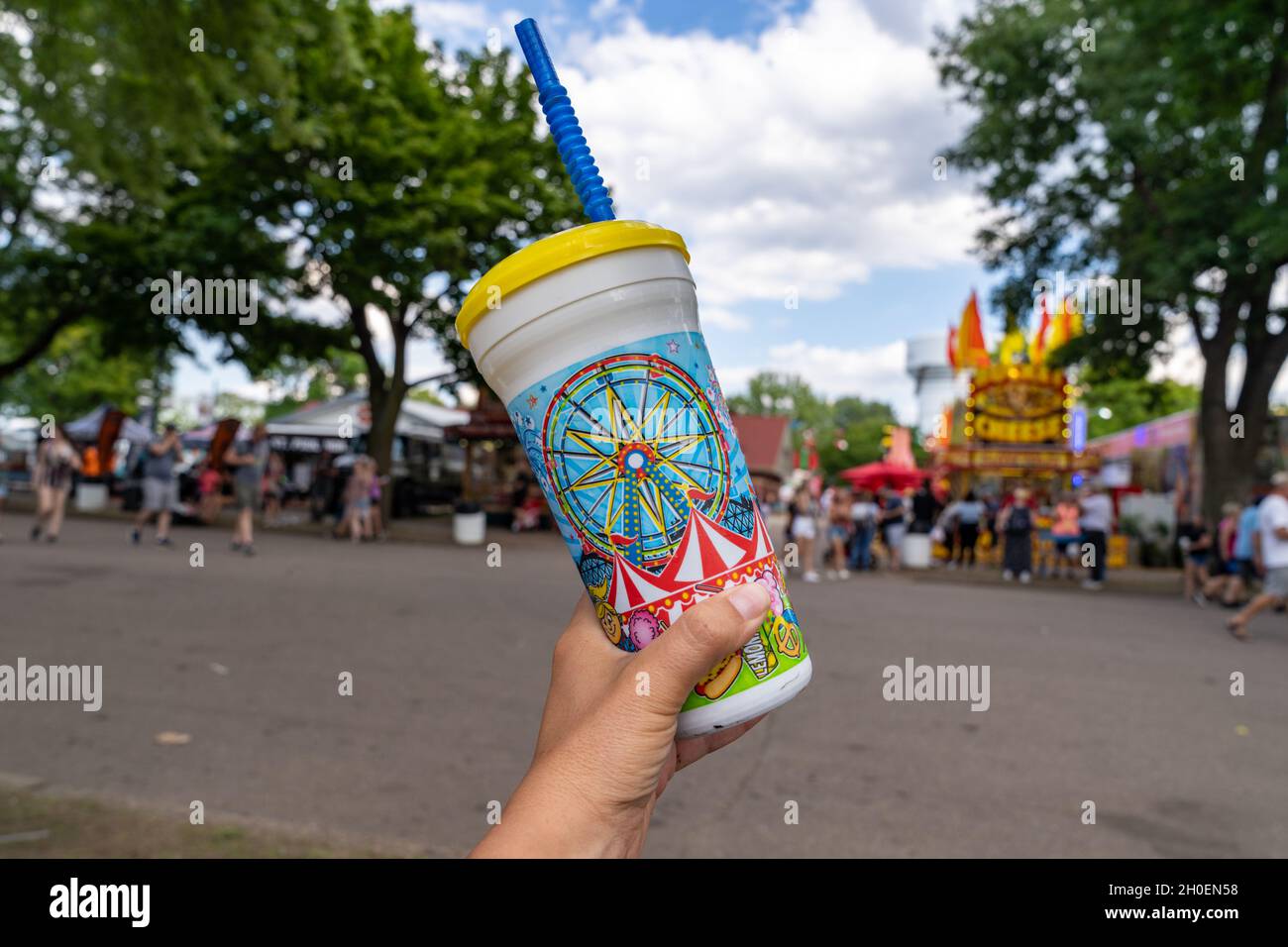 St. Paul, Minnesota - August 30, 2021: Hand holds up a souviner soda cup with pop at the Minnesota State Fair Stock Photo