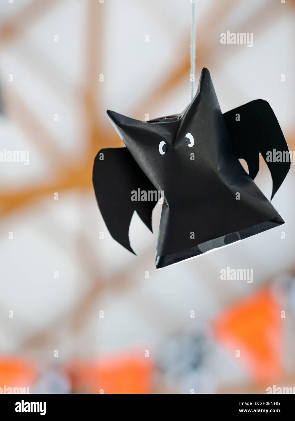 Origami bat made of black paper hanging on a rope for Halloween decorations.  Dark paper ghost Halloween party concept origami paper bat. The figure of  Stock Photo - Alamy