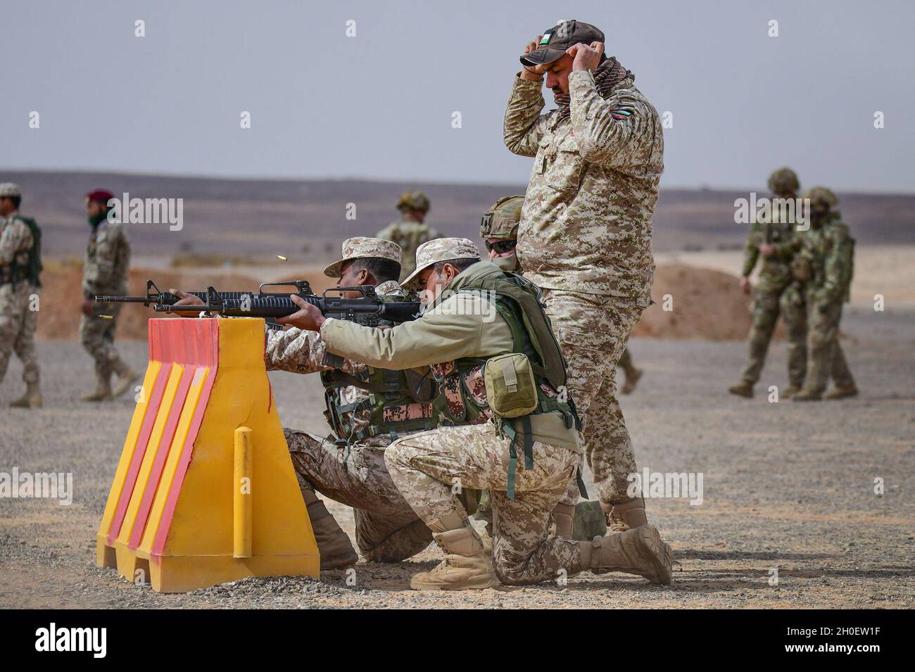 A U.S. Soldier and Jordanian military range instructor watch shell 