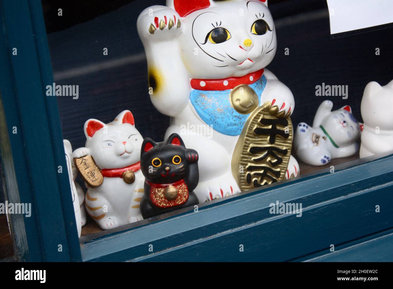 Lucky cats in shop window. Stock Photo