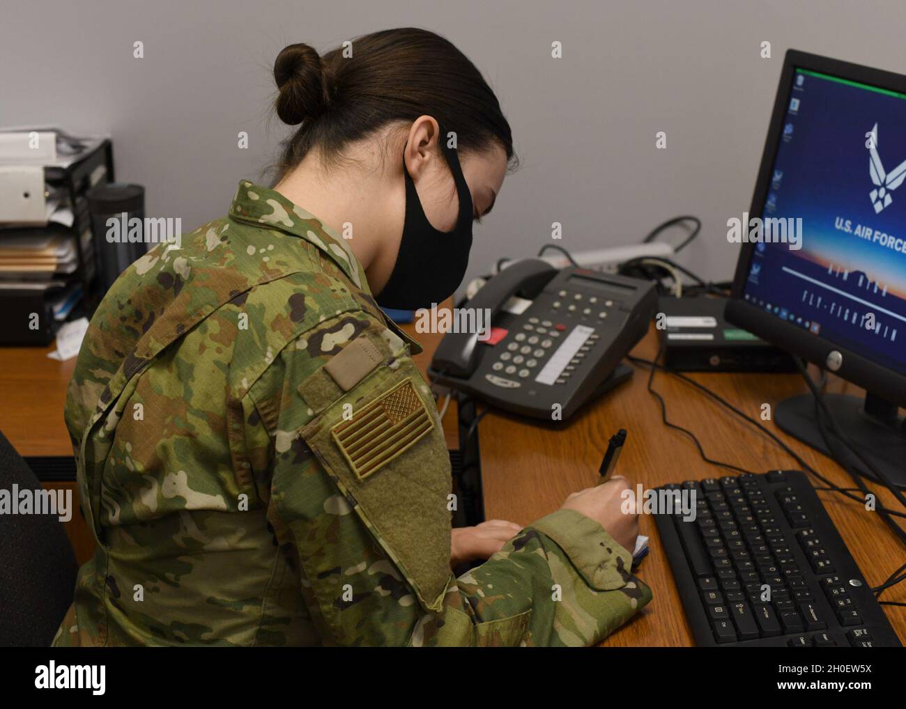 Senior Airman Weronika Baczek, public health technician, 104th Medical Group, takes down notes about a patient, in her office at Barnes Air National Guard Base, Massachusetts, Feb. 17, 2021. Contact tracing is critical for safeguarding 104th Fighter Wing mission readiness and the health of our Barnestormers and surrounding communities from COVID-19. Stock Photo