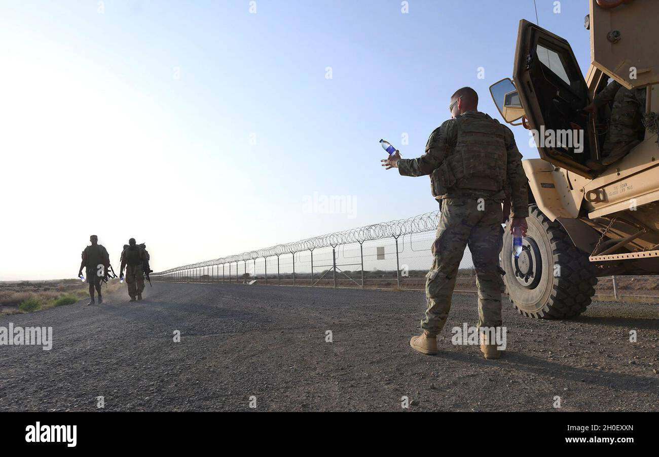 CHABELLEY AIRFIELD, Djibouti (Feb. 18, 2021) U.S. Army Staff Sgt., Bryan  Ward, assigned to Charlie Company, 2nd Battalion, 135th Infantry Regiment,  hands out water during an honorary ruck march on Feb 18,