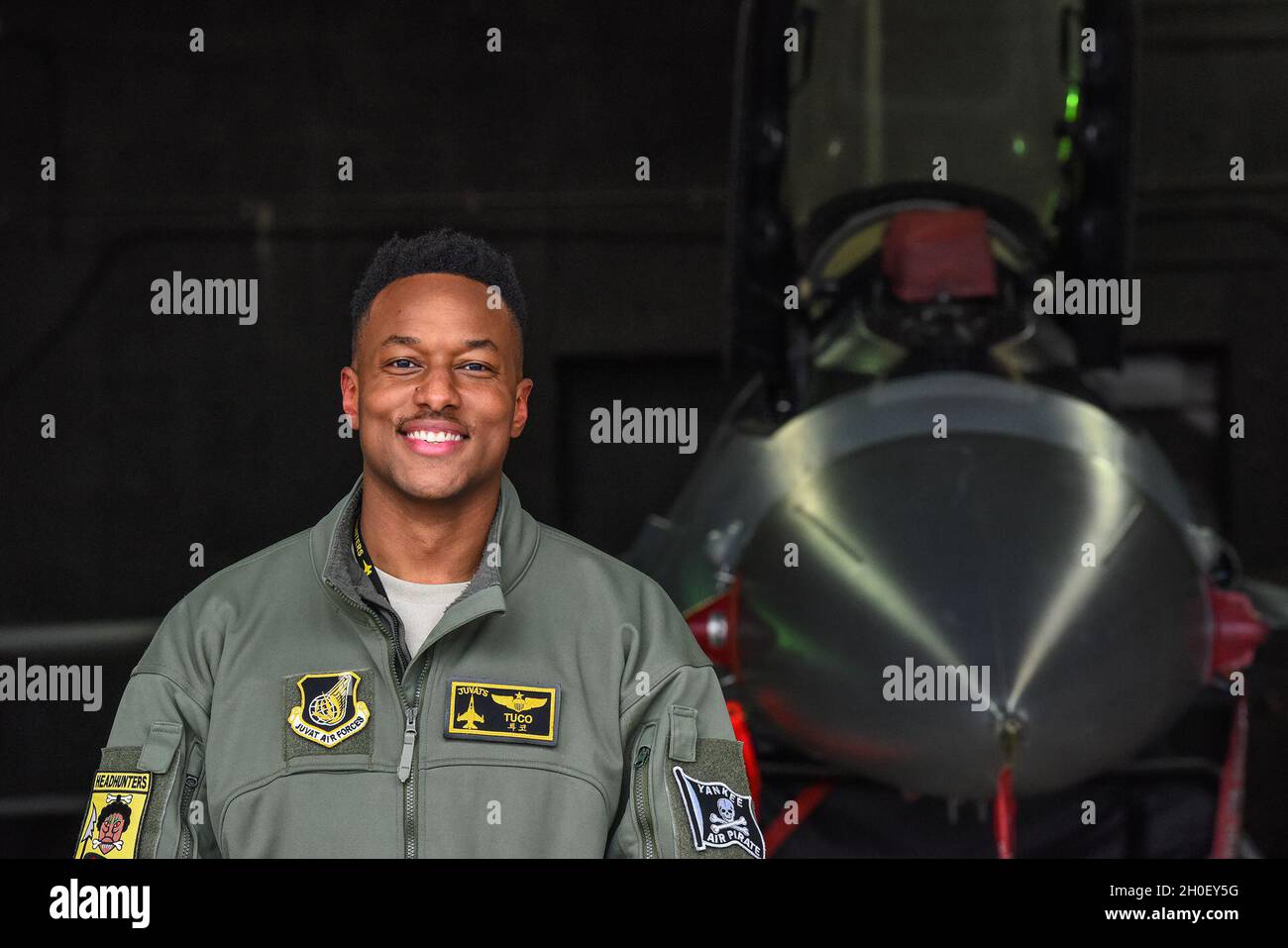 Maj. Chris 'Tuco' Harrison, 80th Fighter Squadron assitant director of operations and chief of standards and evaluations, poses for a photo in front of an F-16 Fighting Falcon on the flightline at Kunsan Air Base, Republic of Korea, Feb. 18, 2021. Harrison commissioned out of Tuskegee University ROTC detachment back in 2011 and follwoed his dream to become a pilot in the U.S. Air Force. Stock Photo