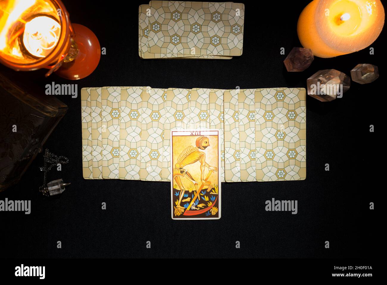Tarot death card on a group of face down cards. Concept of a divination session with tarot cards. View from above. Stock Photo