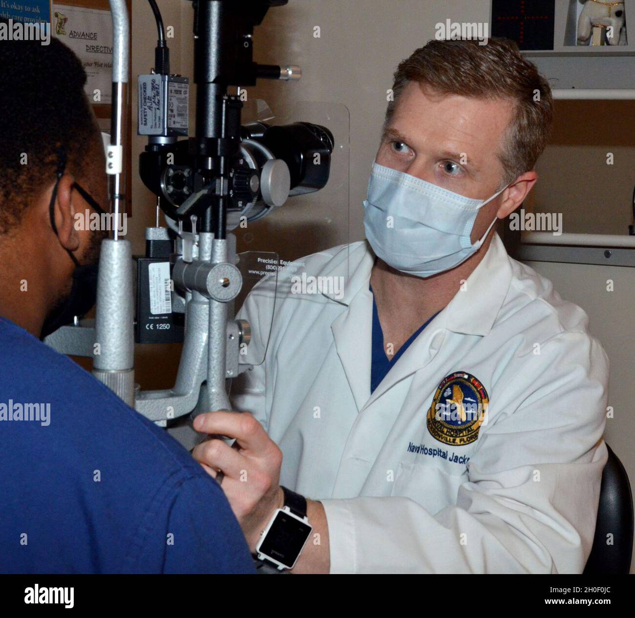 jacksonville-fla-feb-18-2021-justin-stricklin-an-optometrist-at-naval-hospital-jacksonville-uses-a-slit-lamp-microscope-to-examine-a-patient-s-eyes-stricklin-holds-a-doctor-of-optometry-degree-from