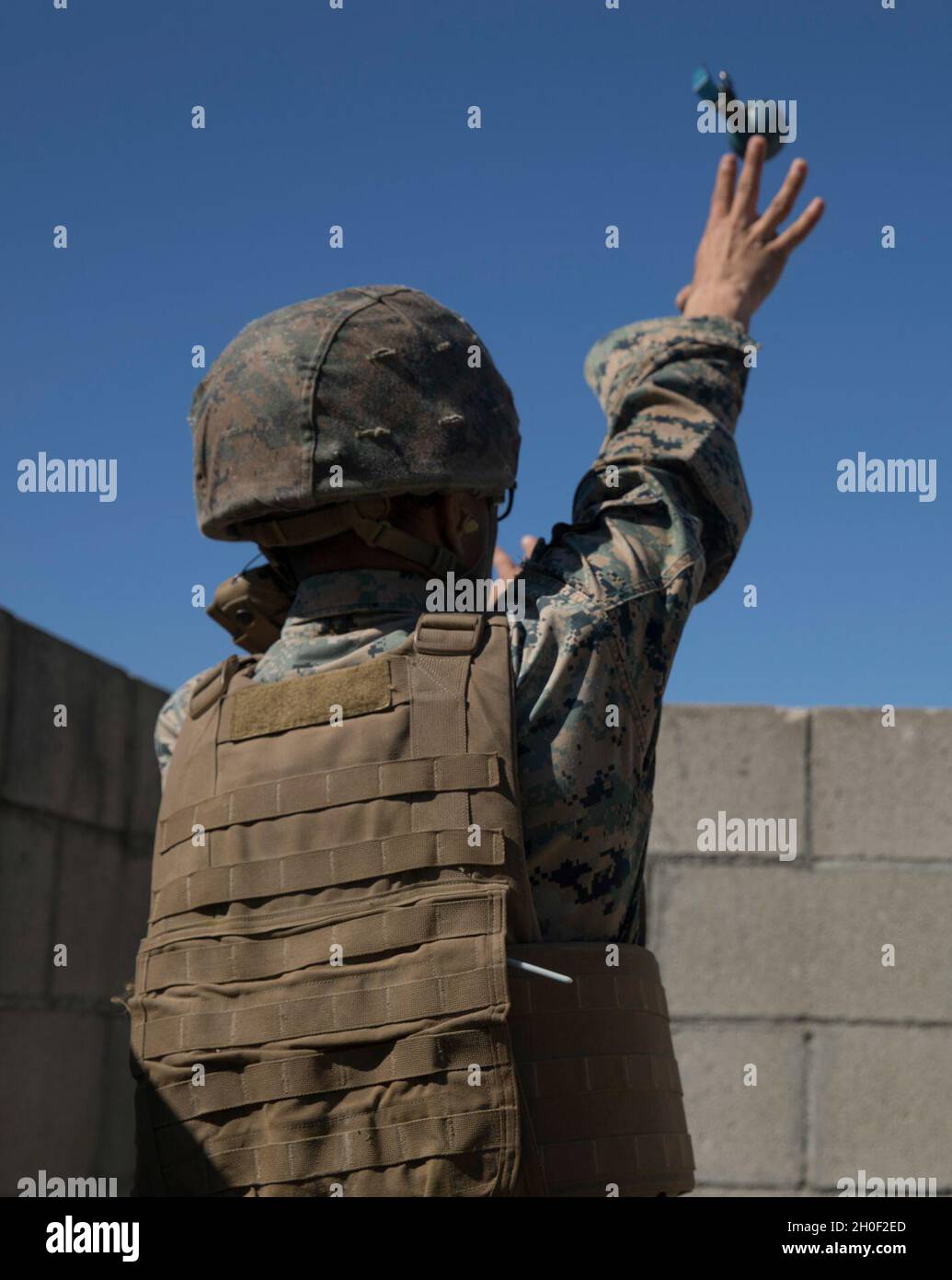 A U.S. Marine with Headquarters Battalion, 1st Marine Division, throws