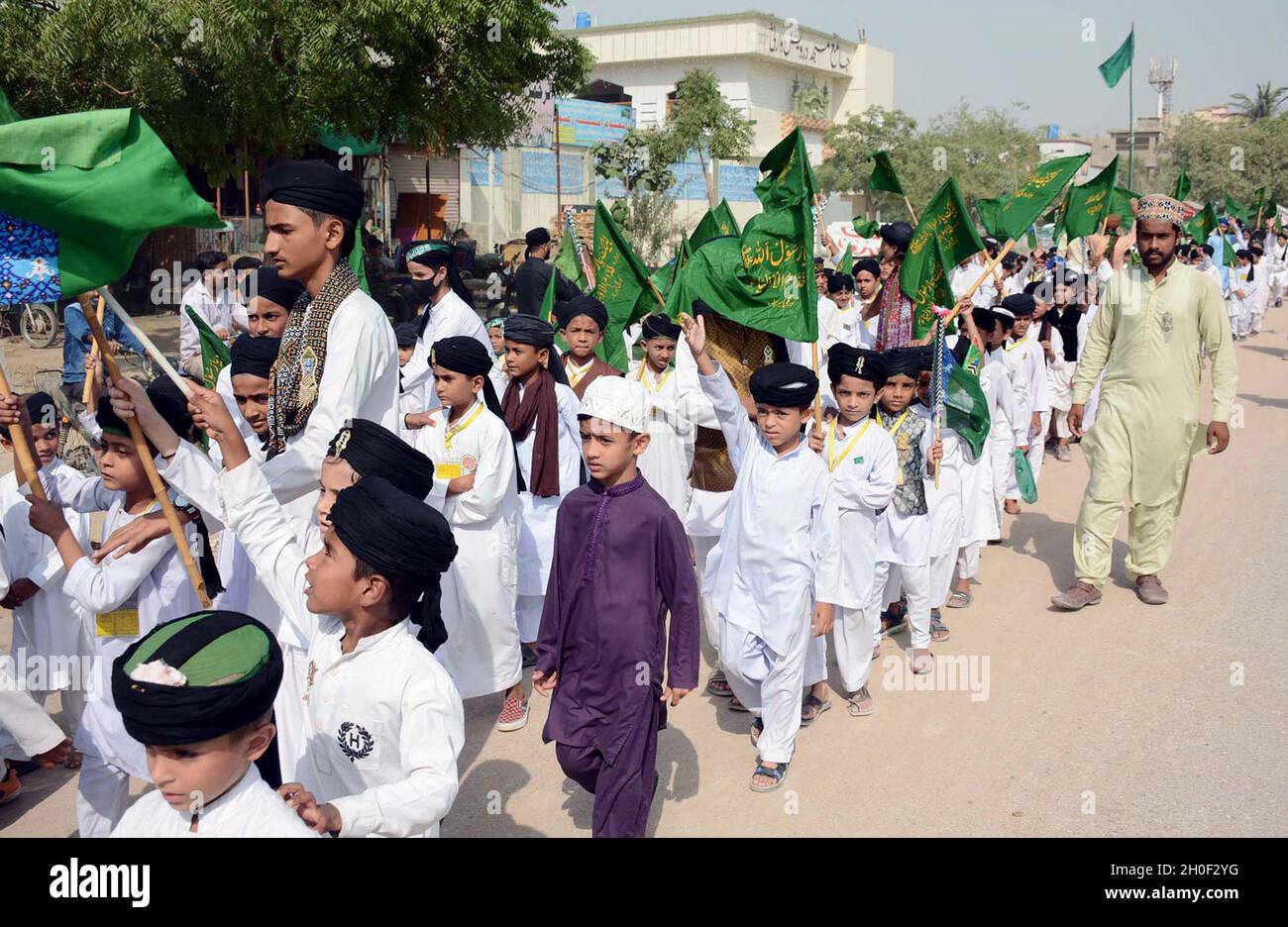 Hyderabad, Pakistan, October 12, 2021. Teachers and students of Islamic Seminary are holding Jashan-e-Eid Milad-un-Nabi (SAW) rally in connection of 12th Rabi-ul-Awwal the Birthday Ceremony of Holy Prophet (P.B.U.H) coming ahead, at Korangi Sector-48 area in Karachi on Tuesday, October 12, 2021. Stock Photo