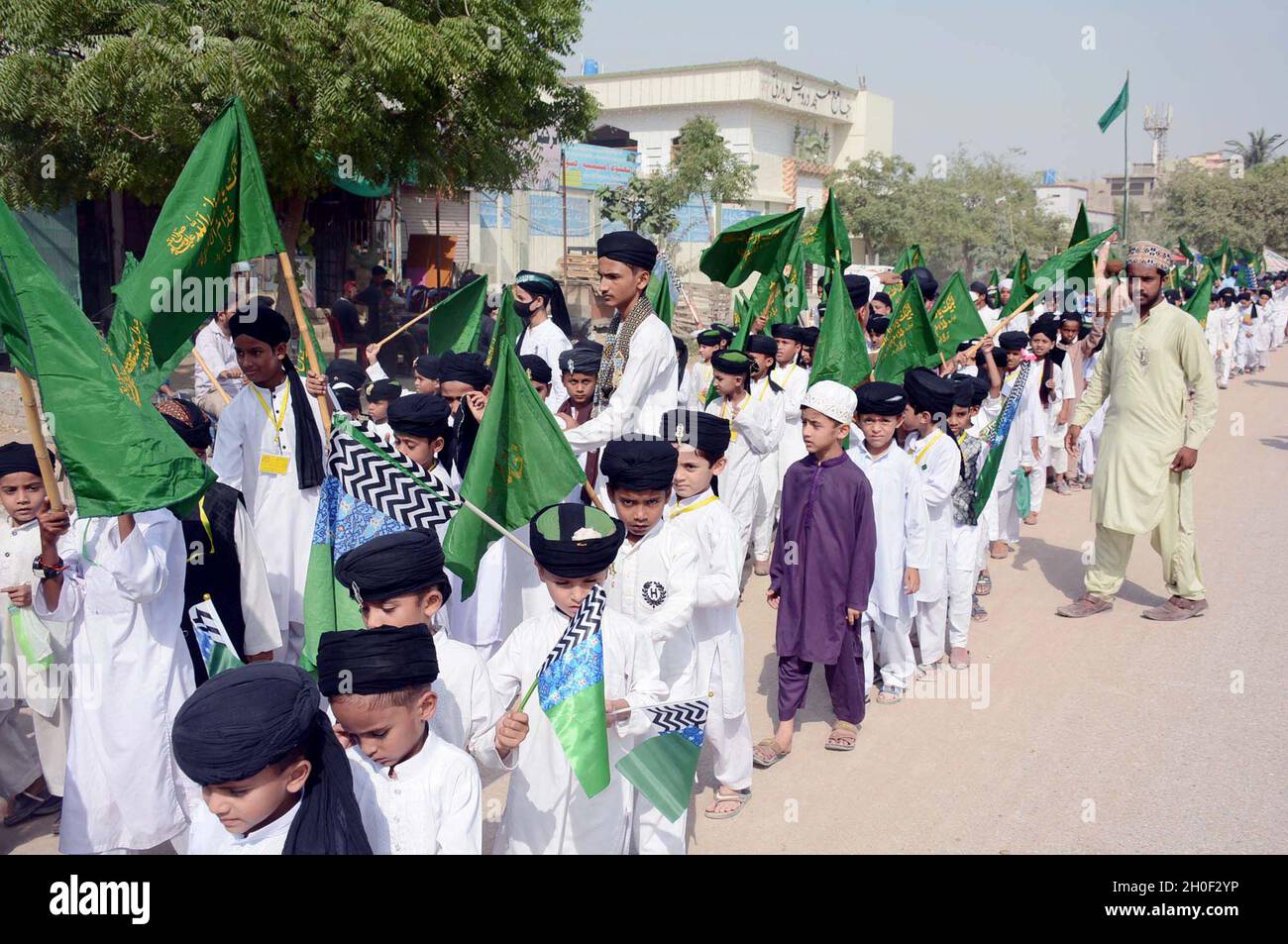 Hyderabad, Pakistan, October 12, 2021. Teachers and students of Islamic Seminary are holding Jashan-e-Eid Milad-un-Nabi (SAW) rally in connection of 12th Rabi-ul-Awwal the Birthday Ceremony of Holy Prophet (P.B.U.H) coming ahead, at Korangi Sector-48 area in Karachi on Tuesday, October 12, 2021. Stock Photo