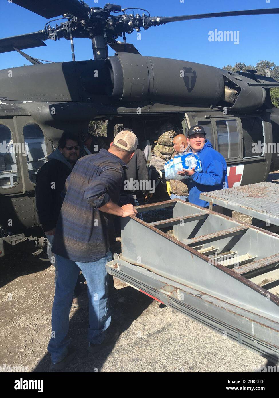 Soldiers of Charlie Company, 2-149th General Aviation Support Battalion, Texas Army National Guard deliver food and water to Texans in response to Winter Storm Uri Feb. 20, 2021, Camp Wood, Texas. Stock Photo