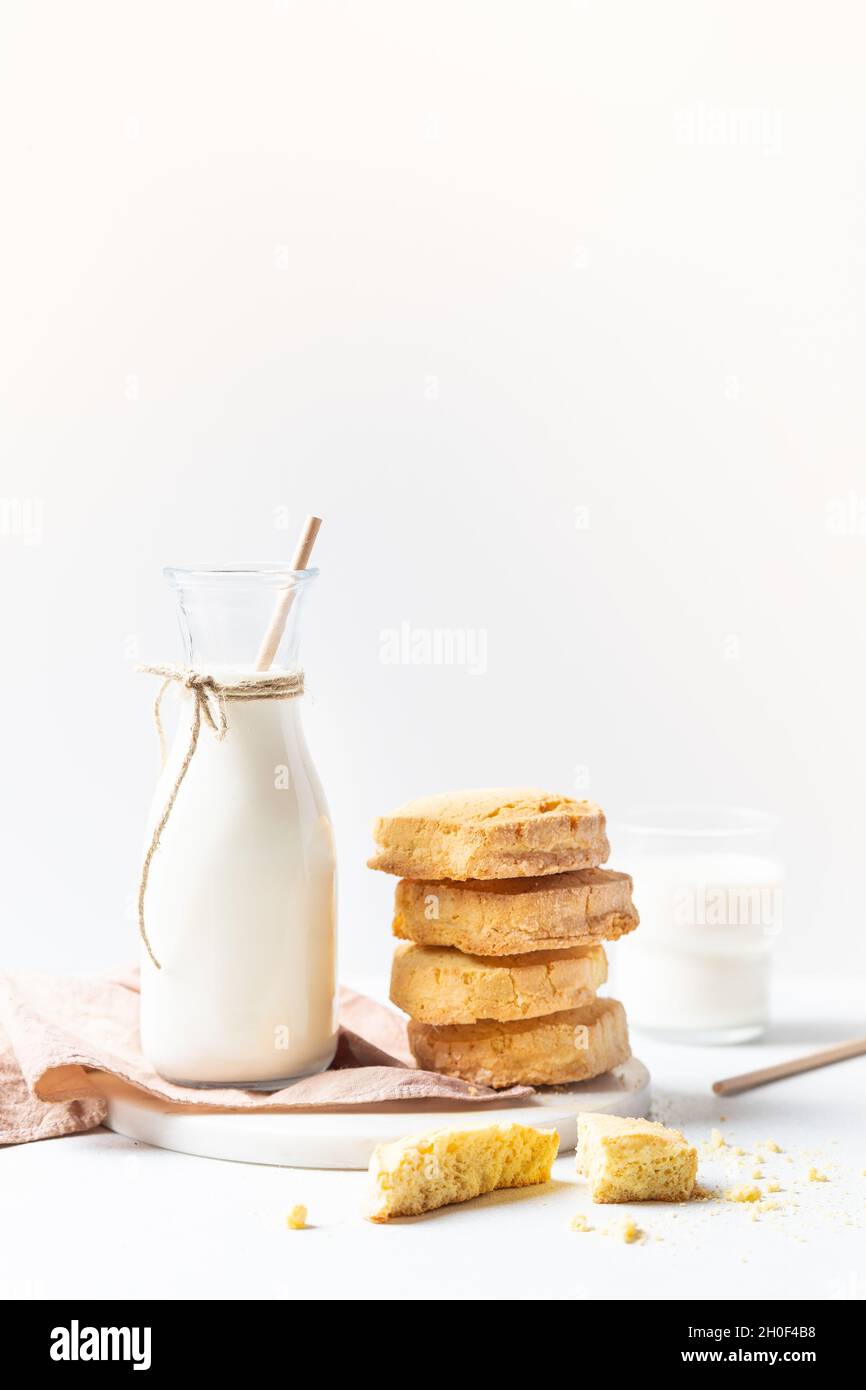 Freshly baked homemade honey cookies with milk for breakfast on a white background Stock Photo