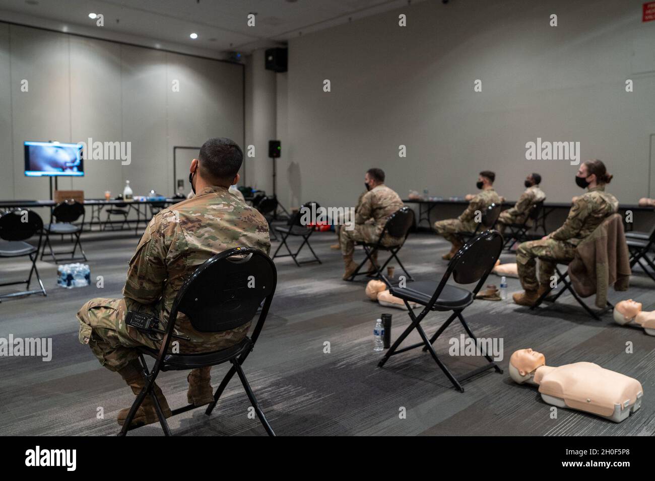 New York National Guard Service Members received a class on Cardiopulmonary resuscitation, which is an emergency procedure that combines chest compressions often with artificial ventilation to manually preserve intact brain function until further measures are taken to restore spontaneous blood circulation and breathing in a person who is in cardiac arrest, from Empress Emergency Medical Services, in support of state efforts to provide mass COVID-19 vaccinations administered by the New York State Department of Health, at the Javits Convention Center in Manhattan, New York, February 22, 2021. Stock Photo